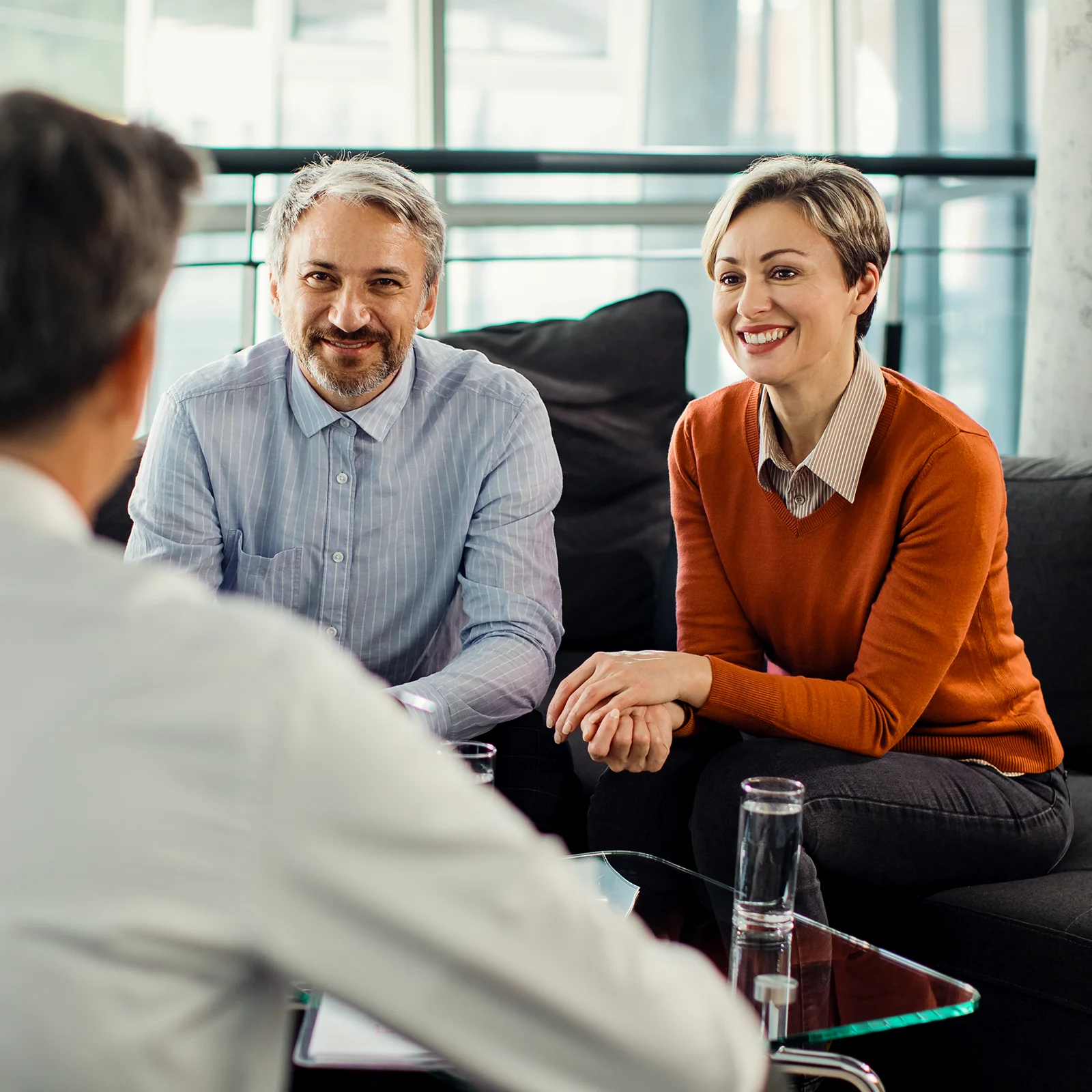 happy couple meeting with christian financial advisor