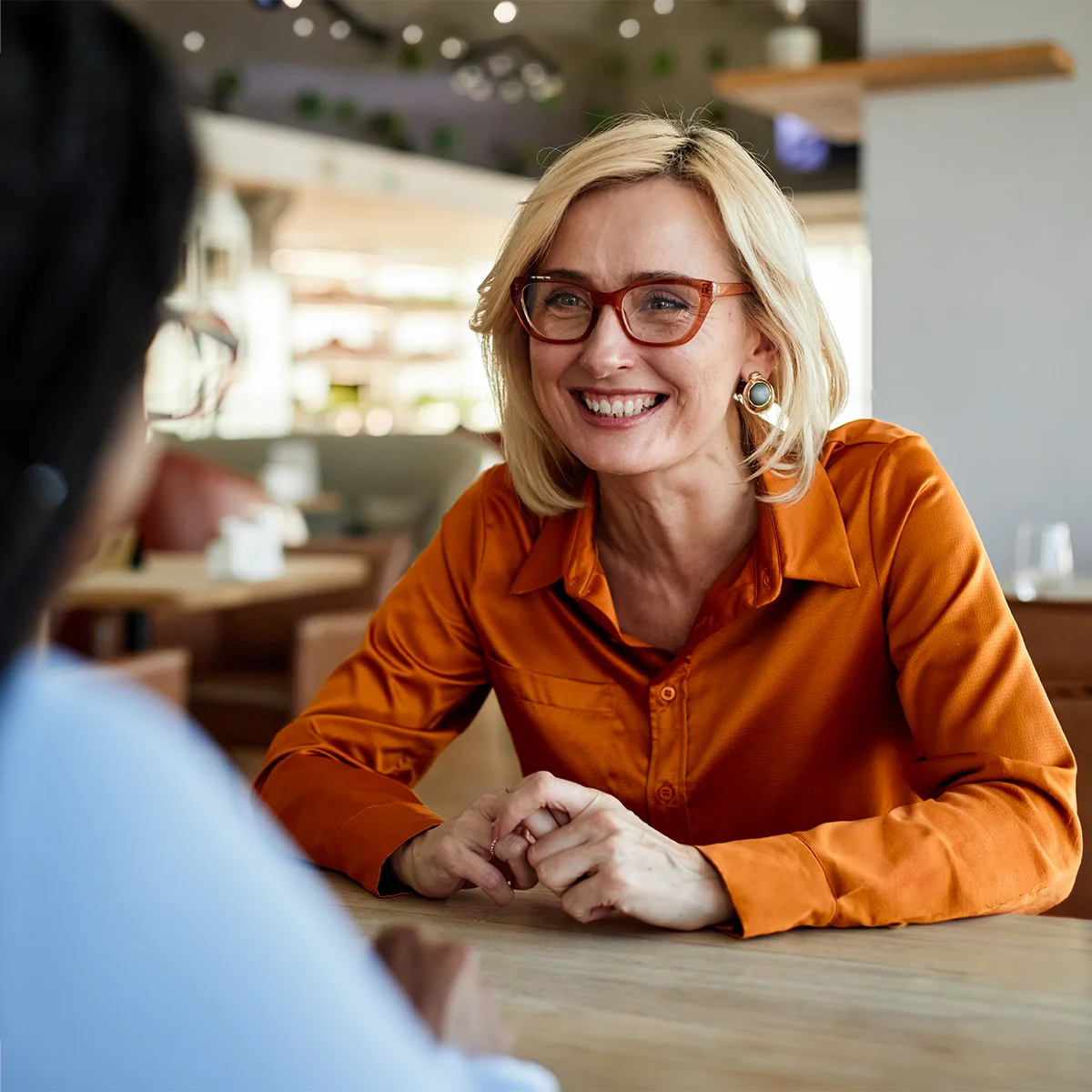 happy middle-aged woman meeting with christian financial planner