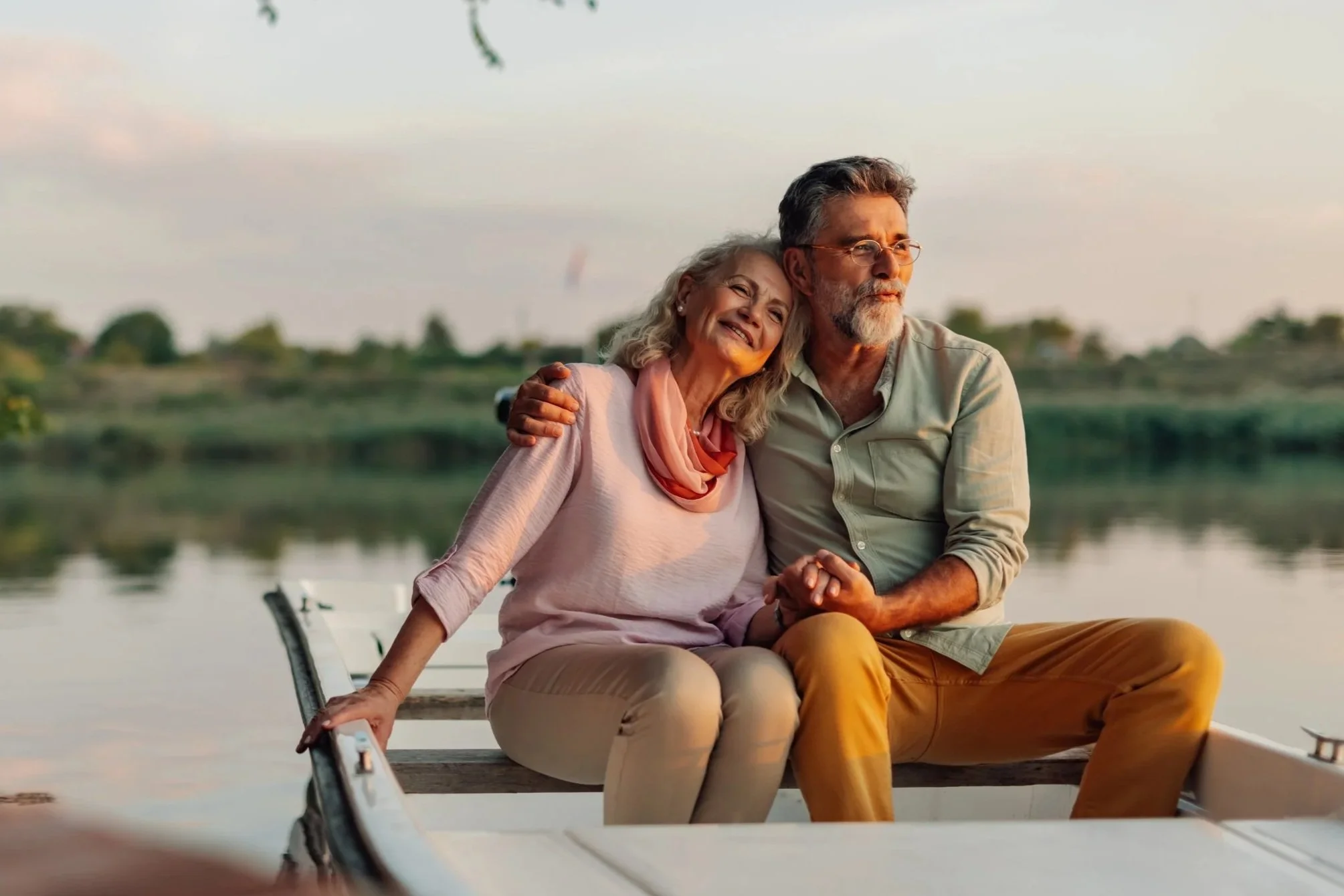 senior couple enjoying a peaceful sunset boat ride