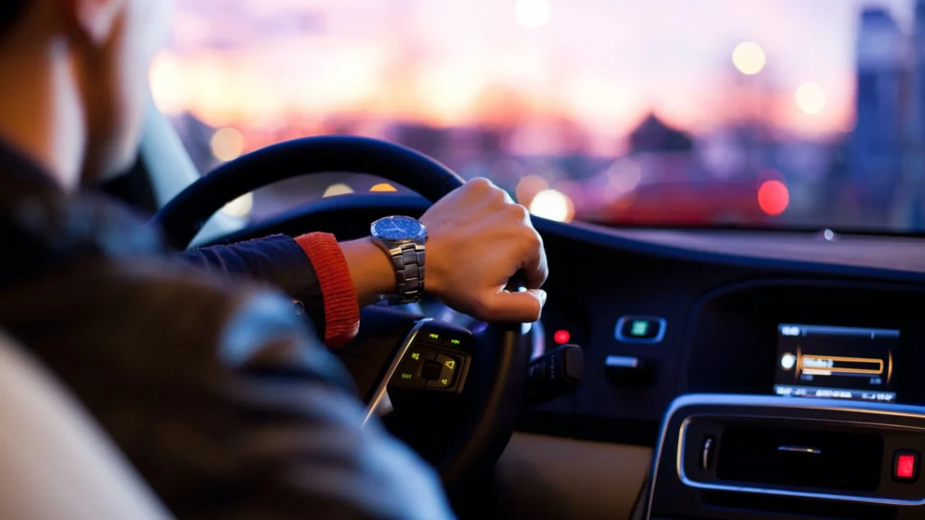 person driving at sunset