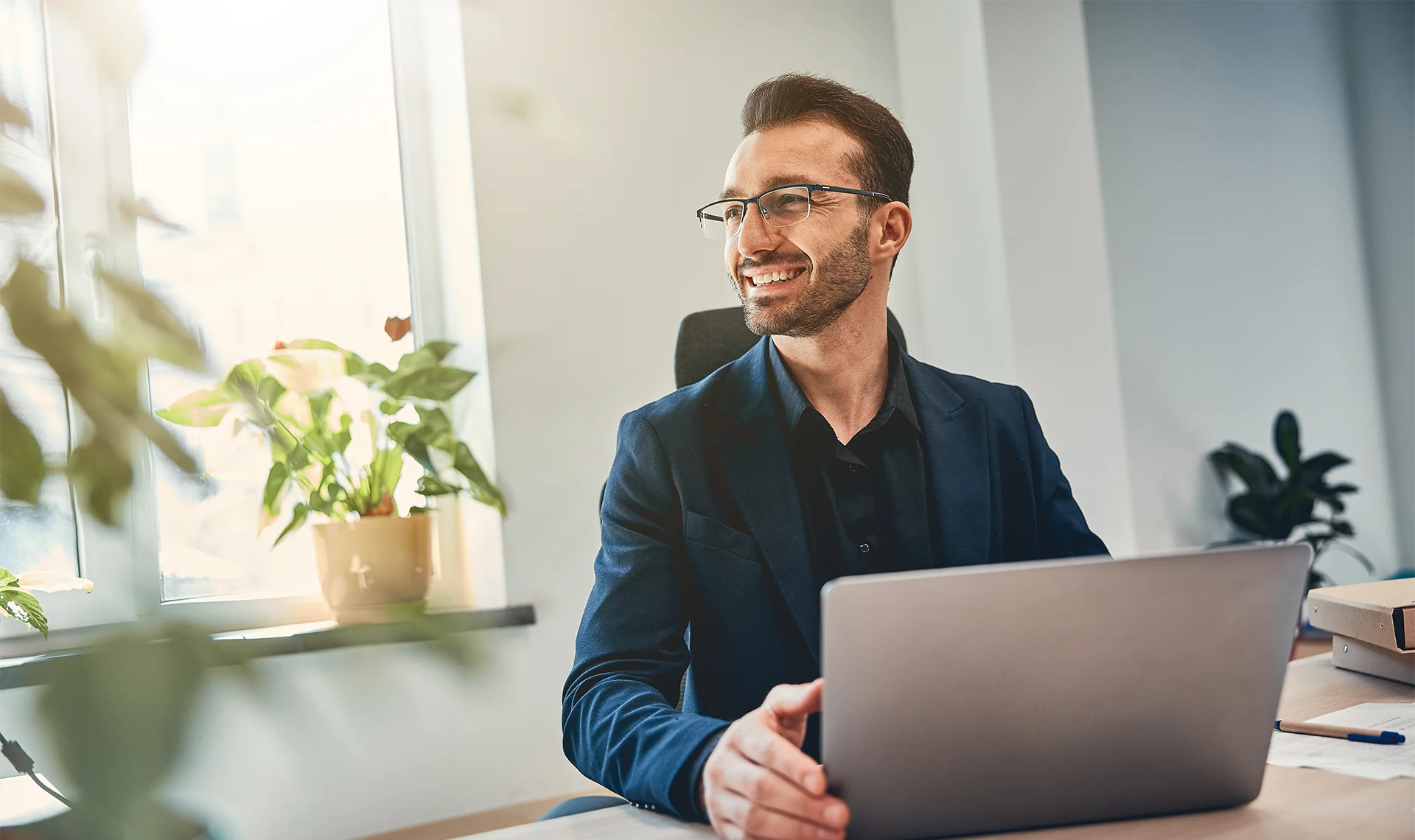 employer working on laptop in office