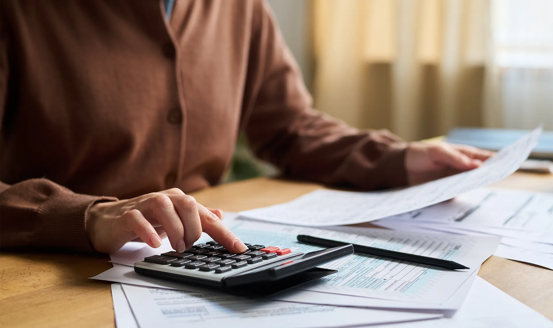 person calculating their taxes at home